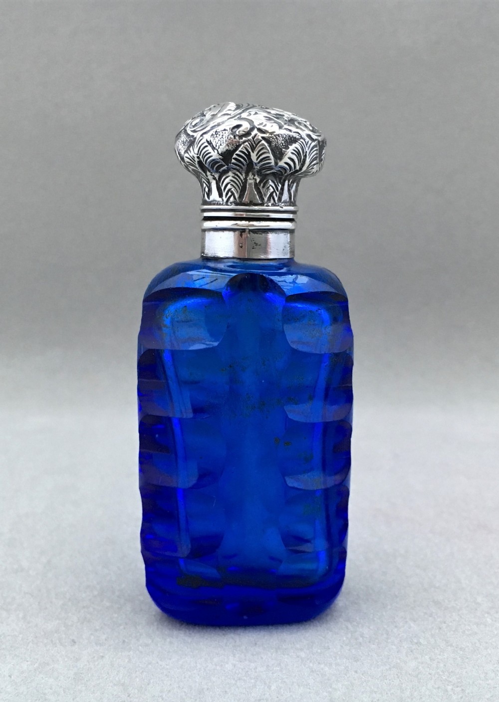 A Stunning Victorian Sapphire blue silver mounted scent bottle.