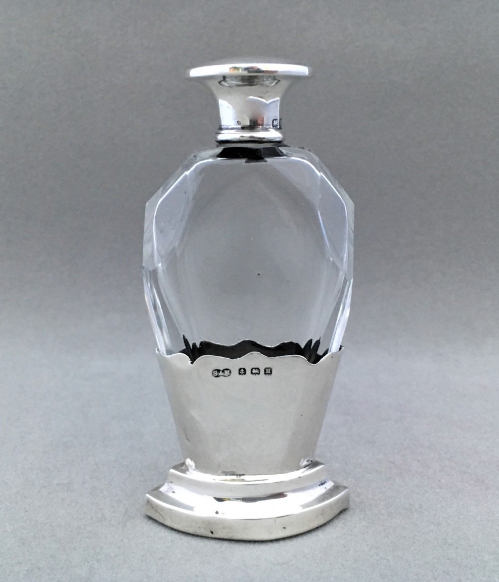 A charming silver mounted cut glass scent bottle.