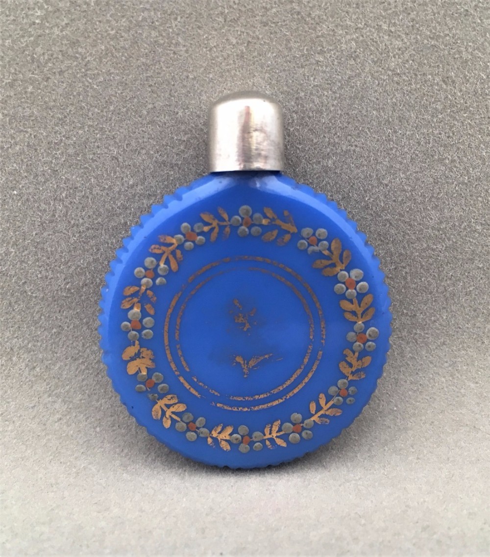 A French Silver mounted coin shaped scent bottle.
