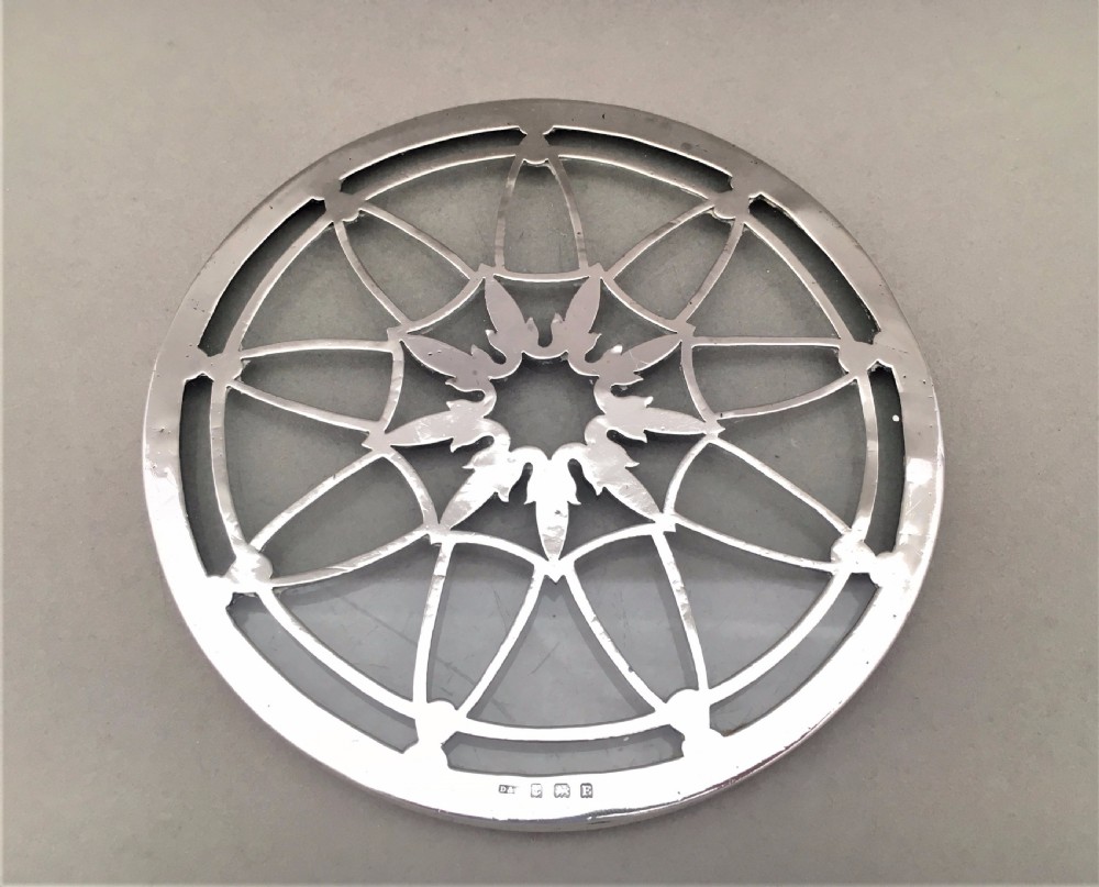An attractive silver teapot stand or coaster.