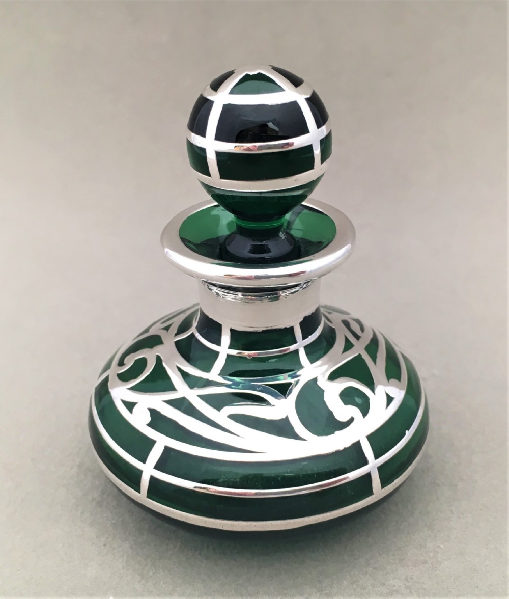 A stunning Victorian silver overlay glass scent bottle