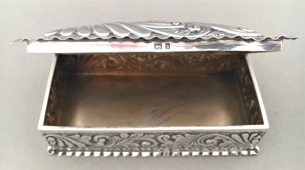 A Victorian repoussé silver trinket box. View VIII