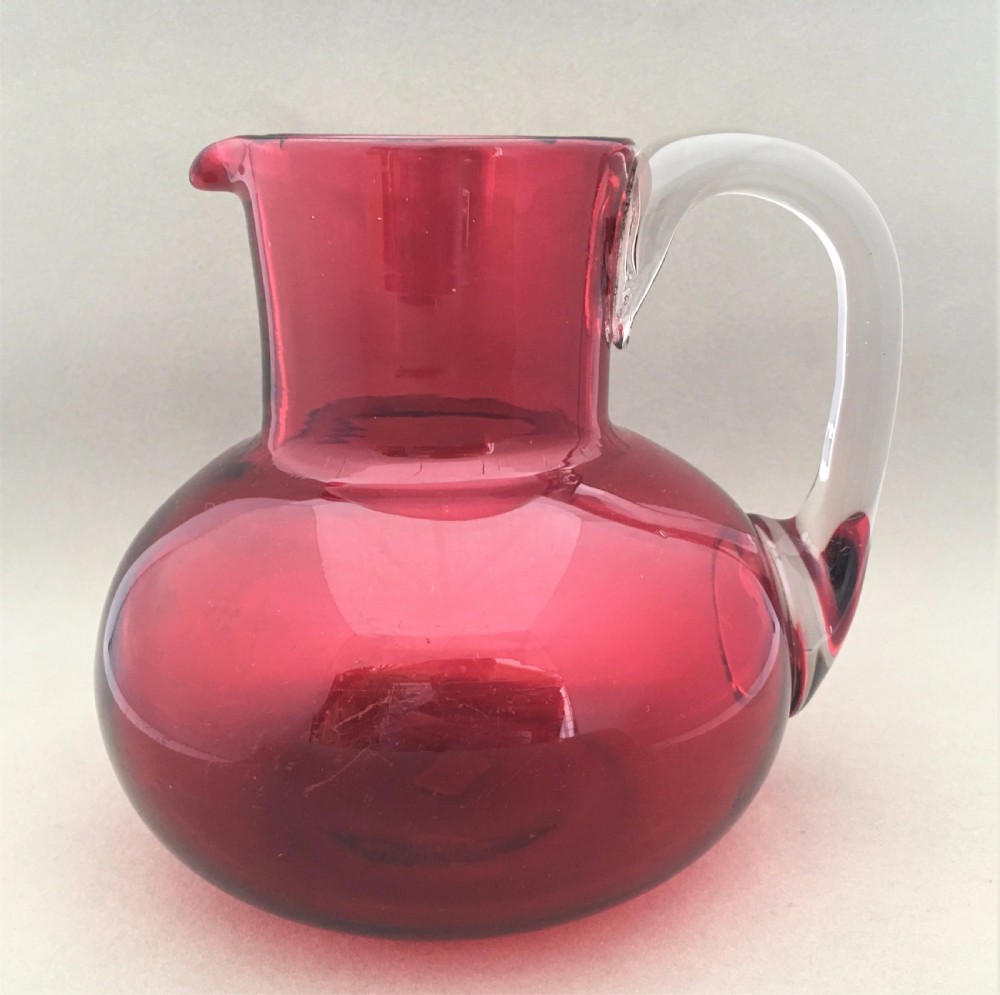 A Victorian Cranberry water jug.