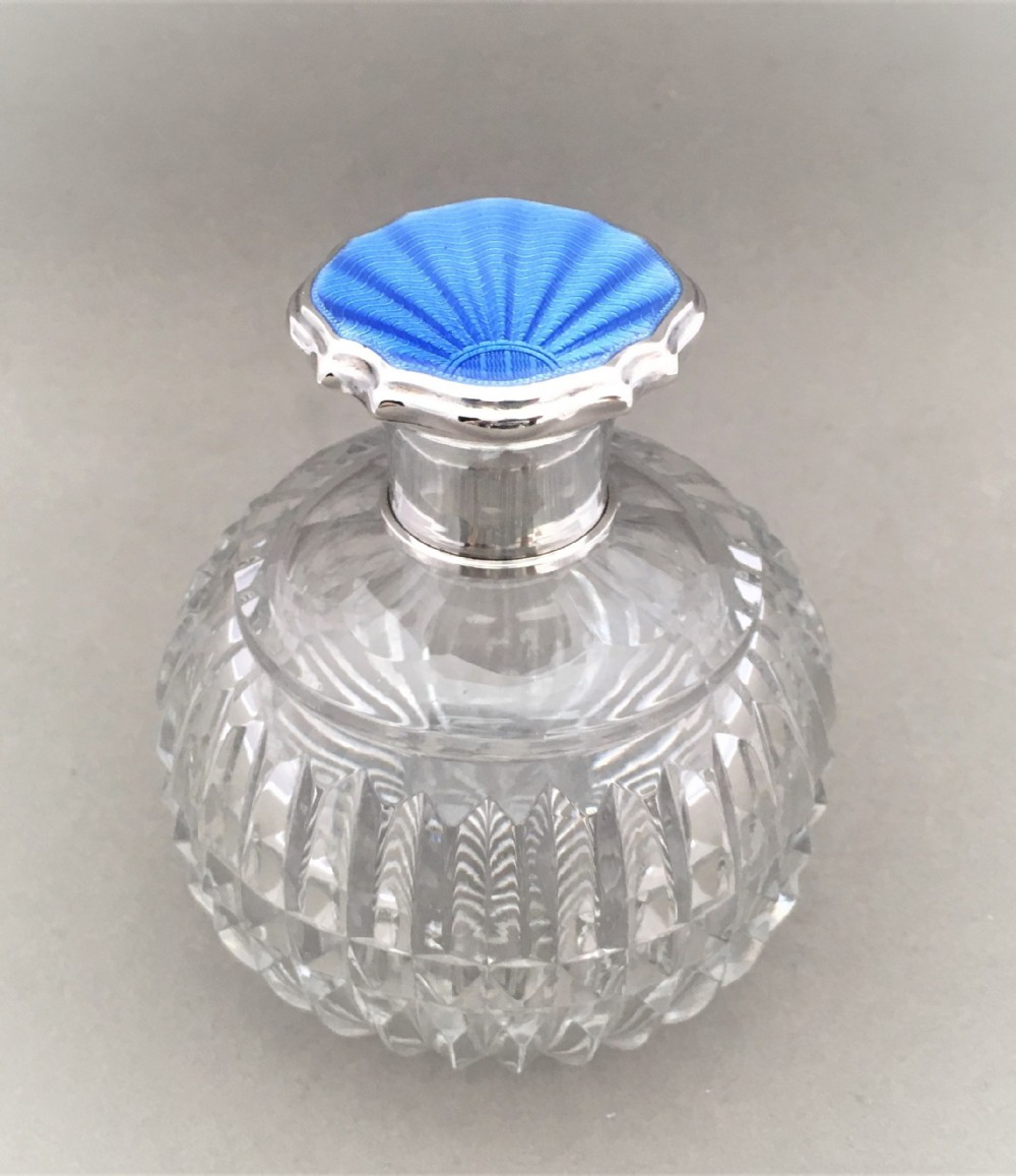 A fabulous silver and GUILLOCHE ENAMEL scent bottle.