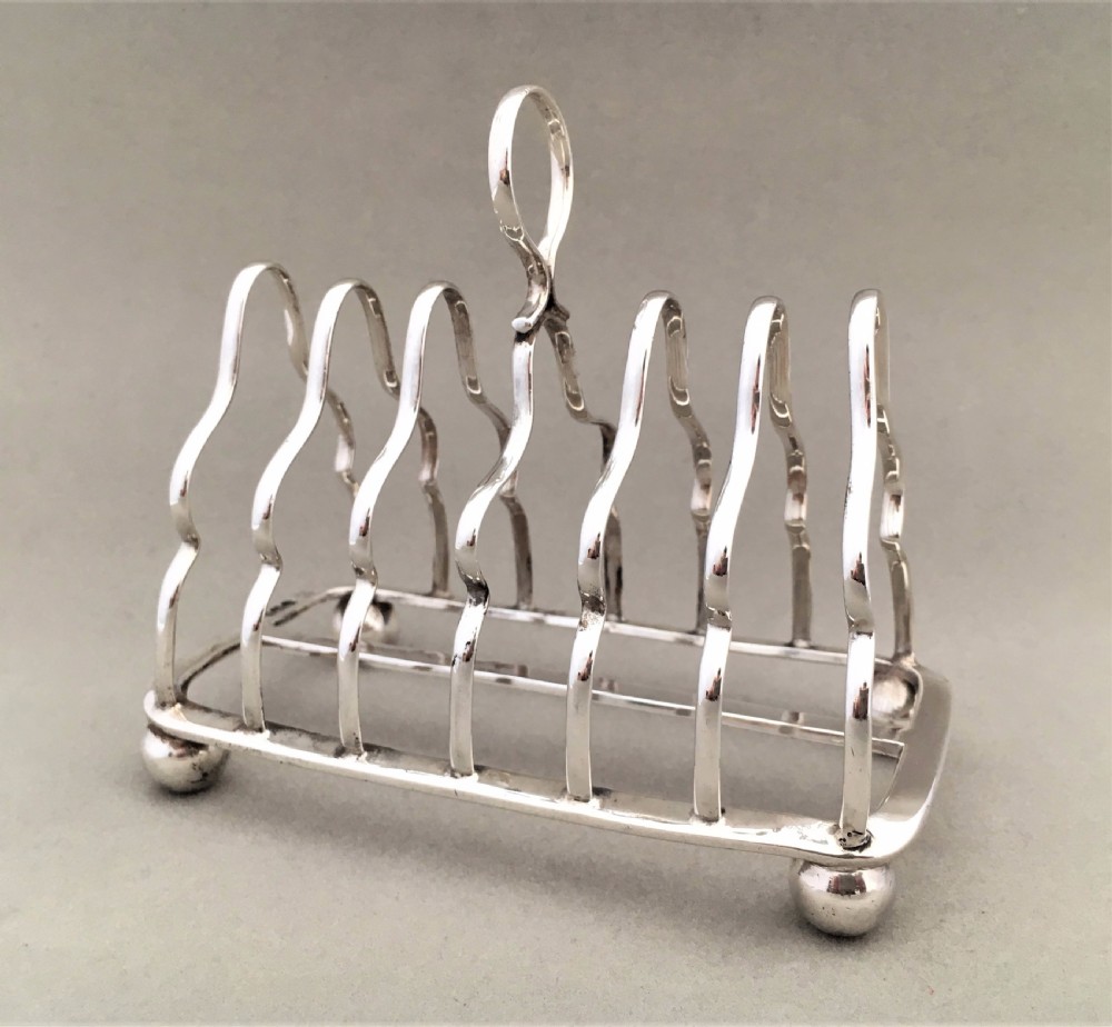 An early George V six slice silver toast rack View II