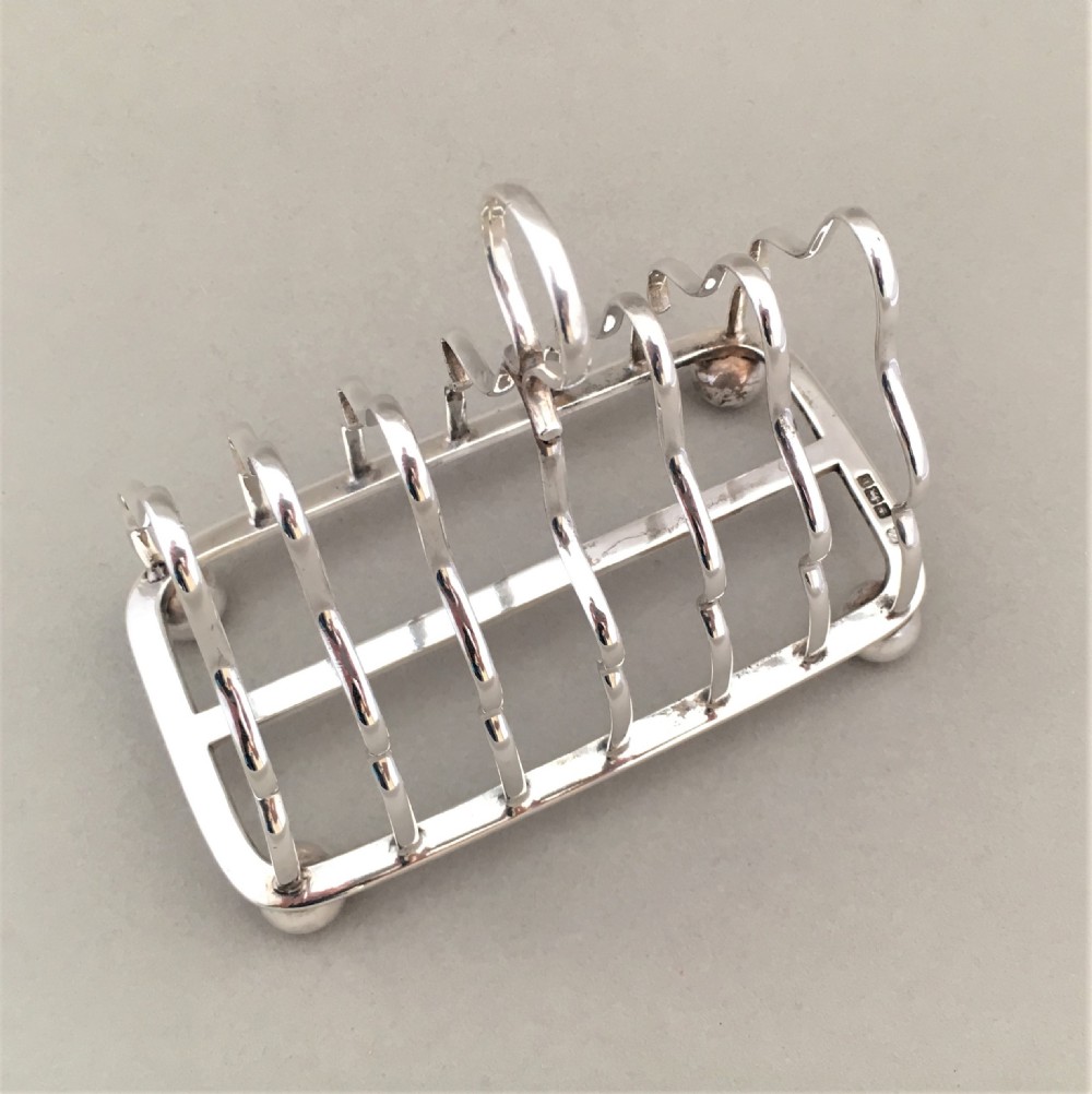 An early George V six slice silver toast rack View IV