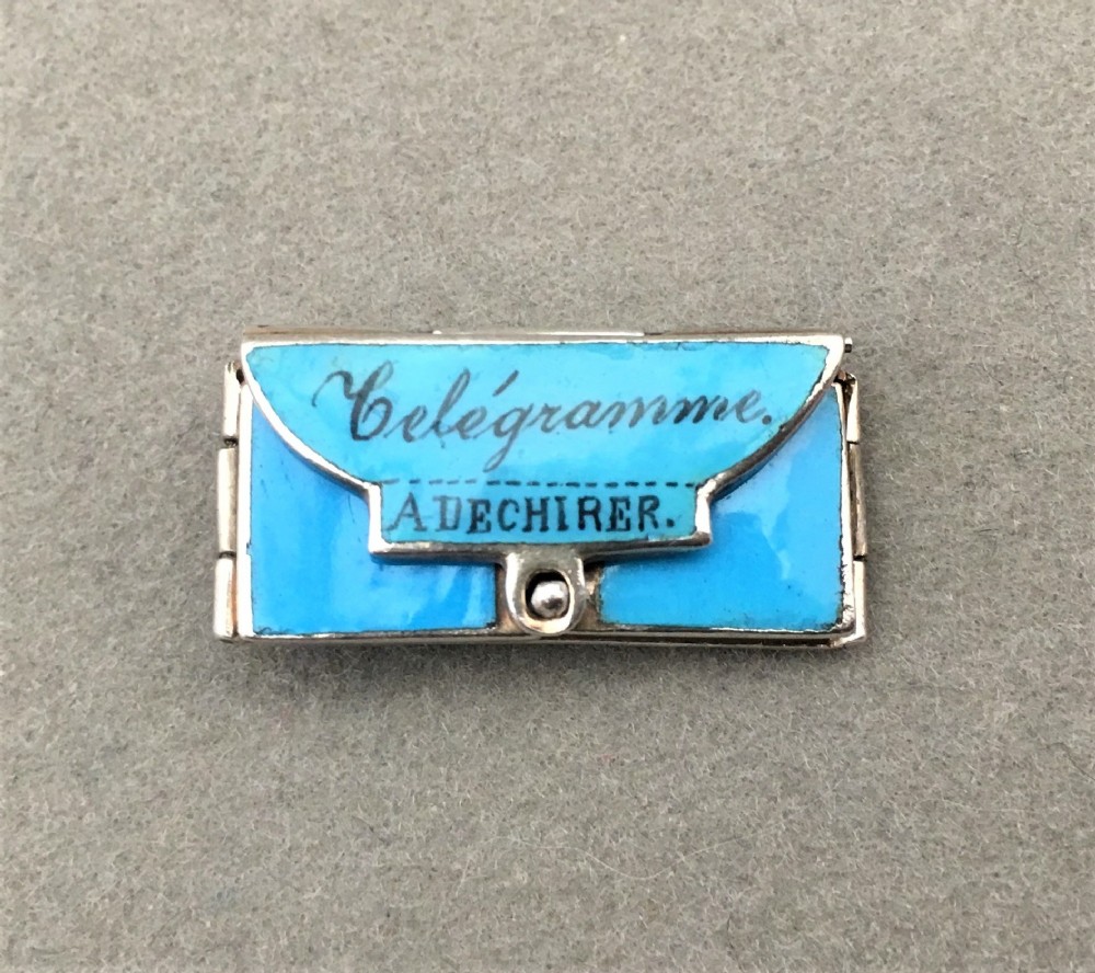 A delightful miniature French silver and enamel sweetheart charm