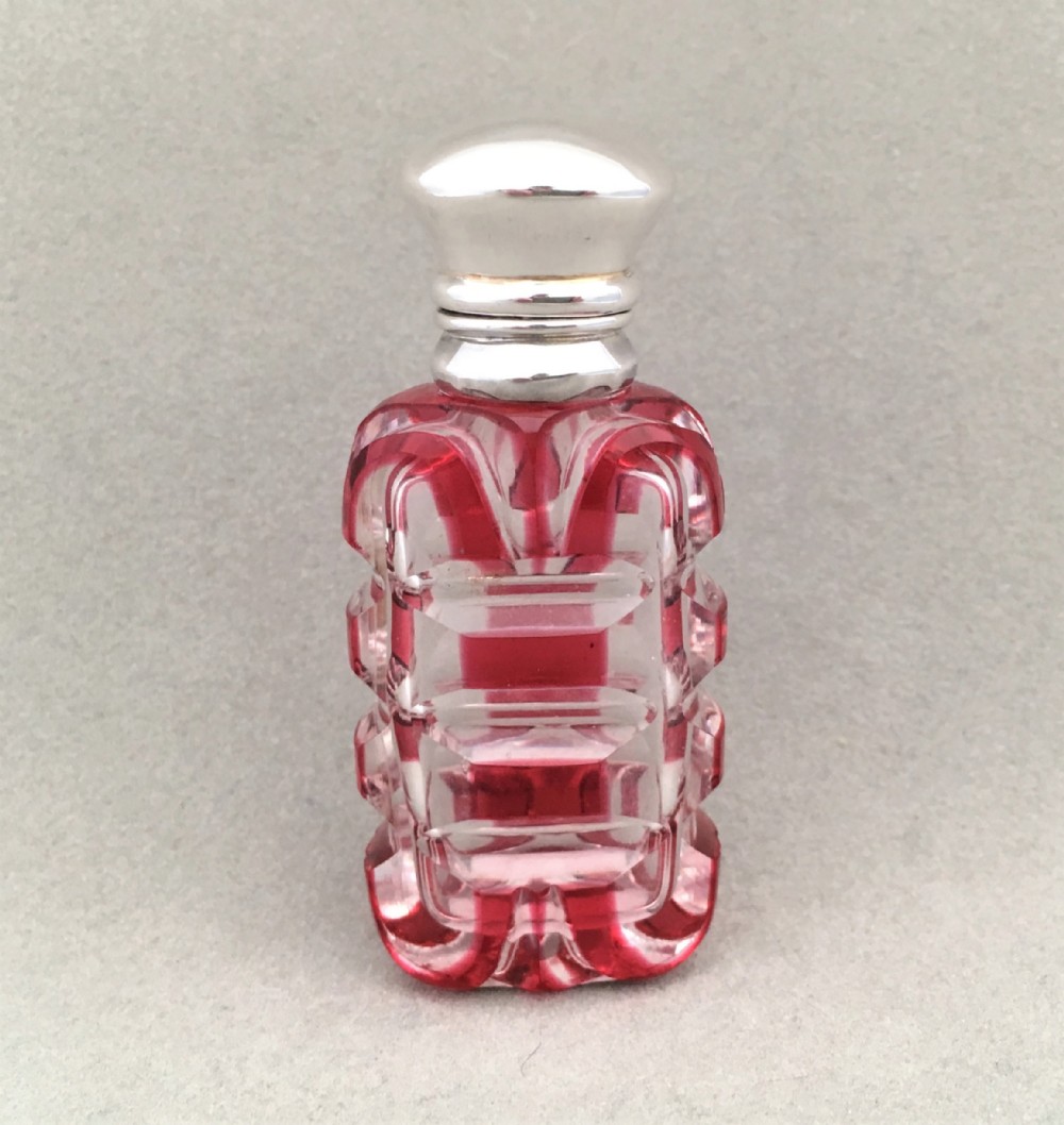 A Victorian silver mounted cranberry scent bottle