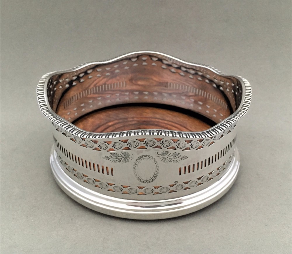 An excellent George V pierced silver wine bottle coaster