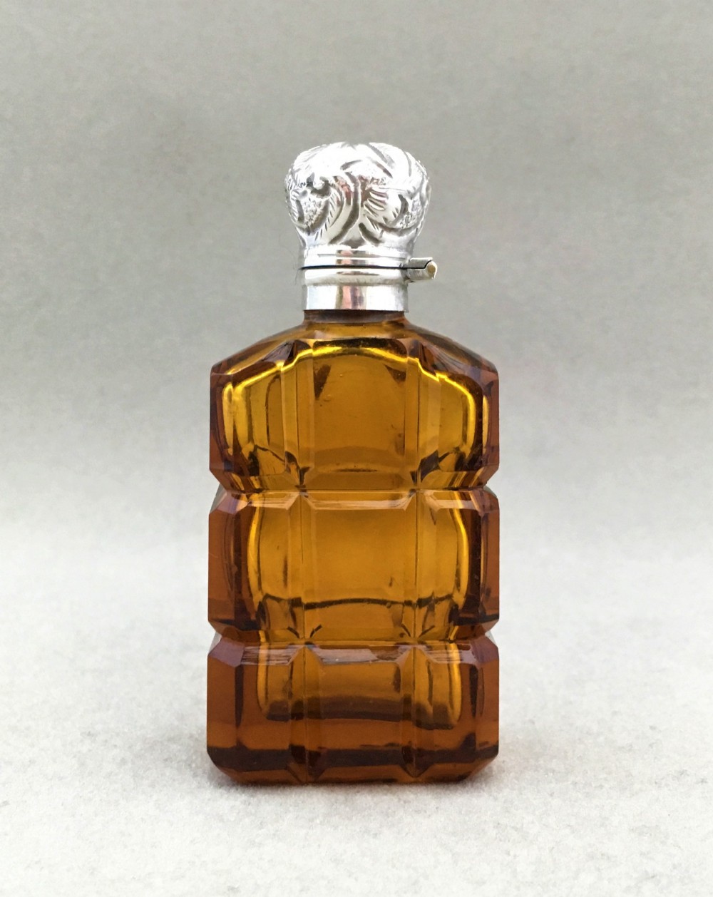 An amber silver mounted Victorian scent bottle
