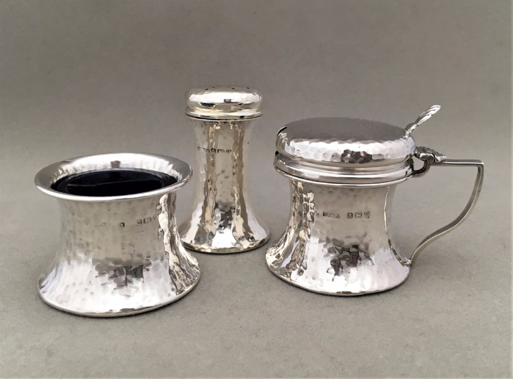 A Silver Arts and Crafts three piece cruet