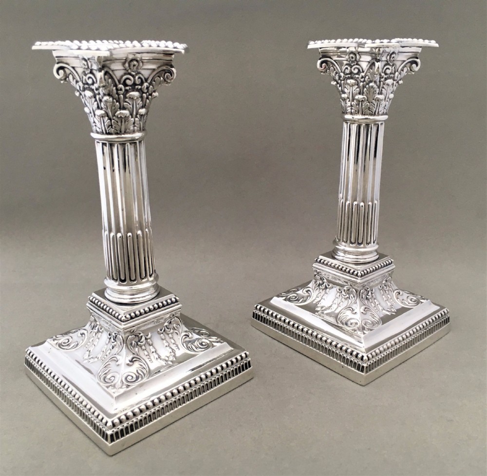 A fabulous pair of Edwardian silver Corinthian column candlesticks