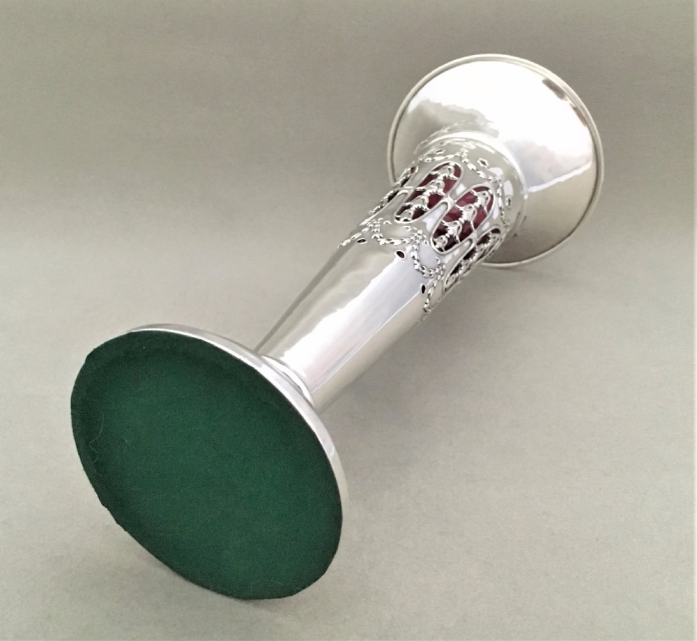 A stunning silver and cranberry pierced trumpet vase View X