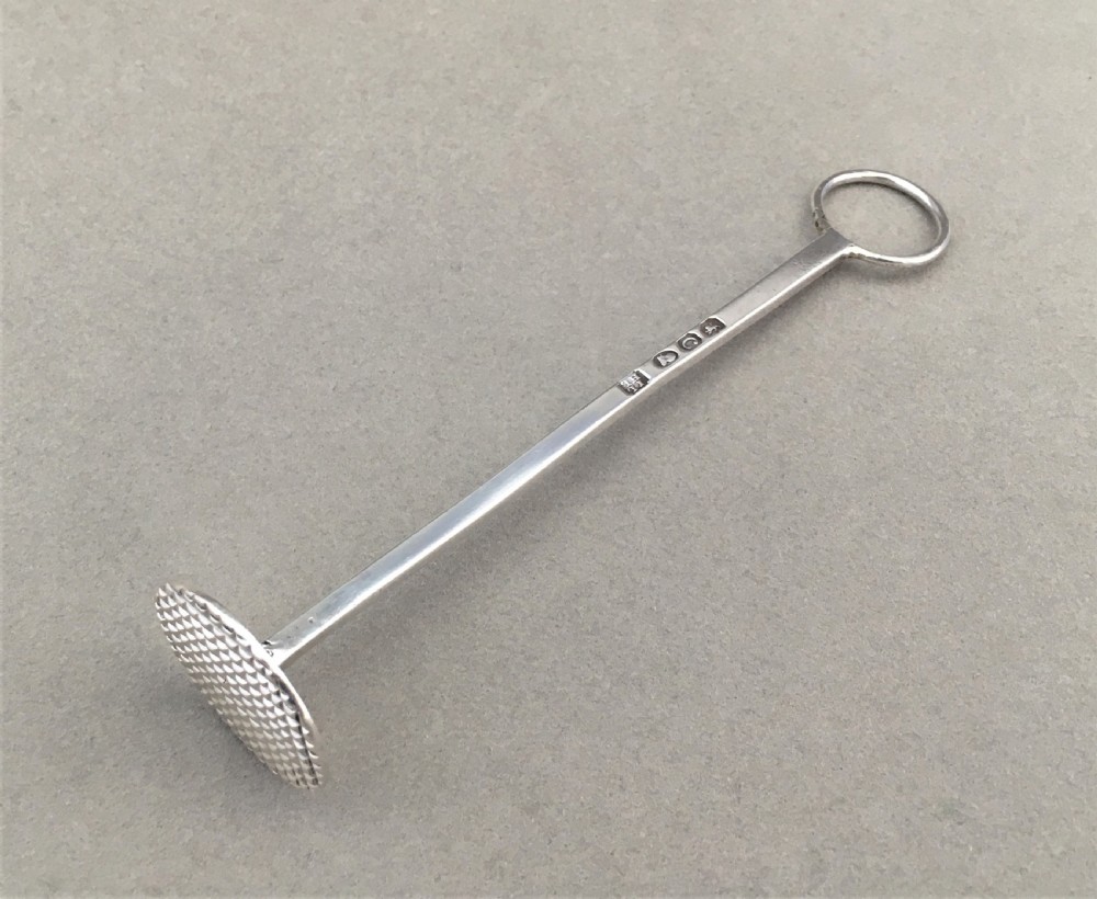 A rare Georgian silver sugar crusher
