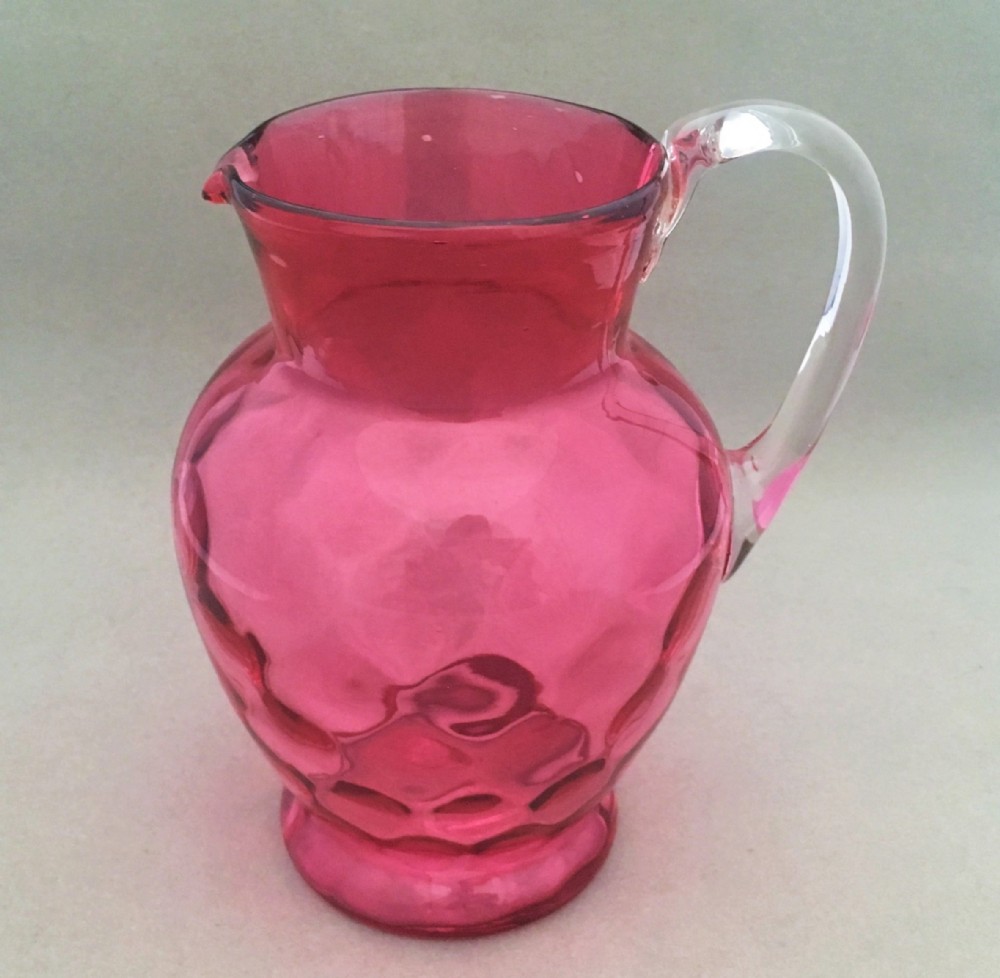 A Victorian dimpled cranberry water jug