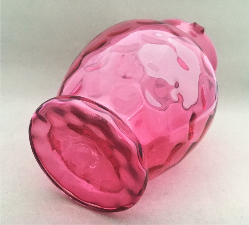 A Victorian dimpled cranberry water jug View V