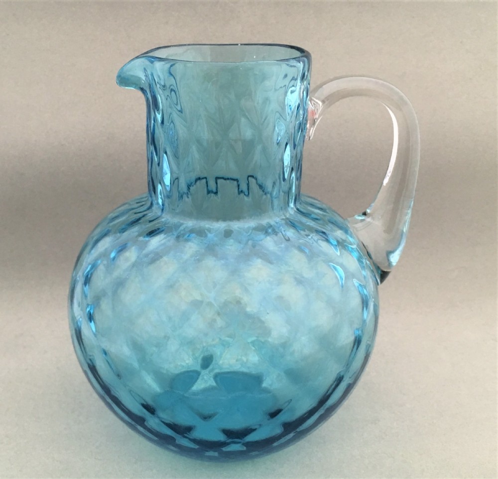 A turquoise blue honeycomb water jug