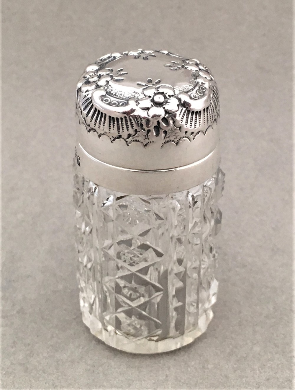 A charming silver mounted cut glass scent bottle
