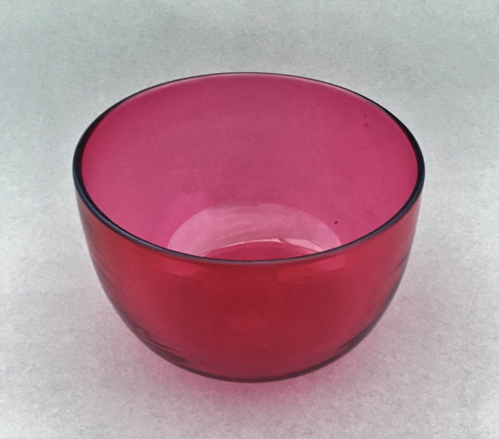 A Victorian cranberry glass finger bowl