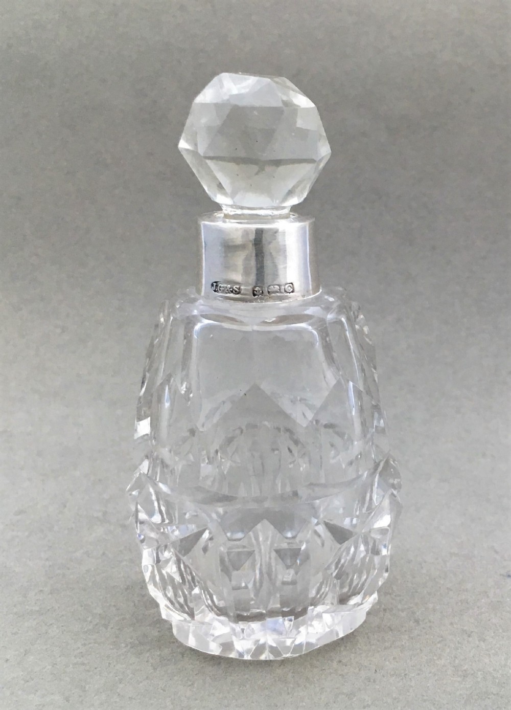 A charming silver mounted cut glass scent bottle