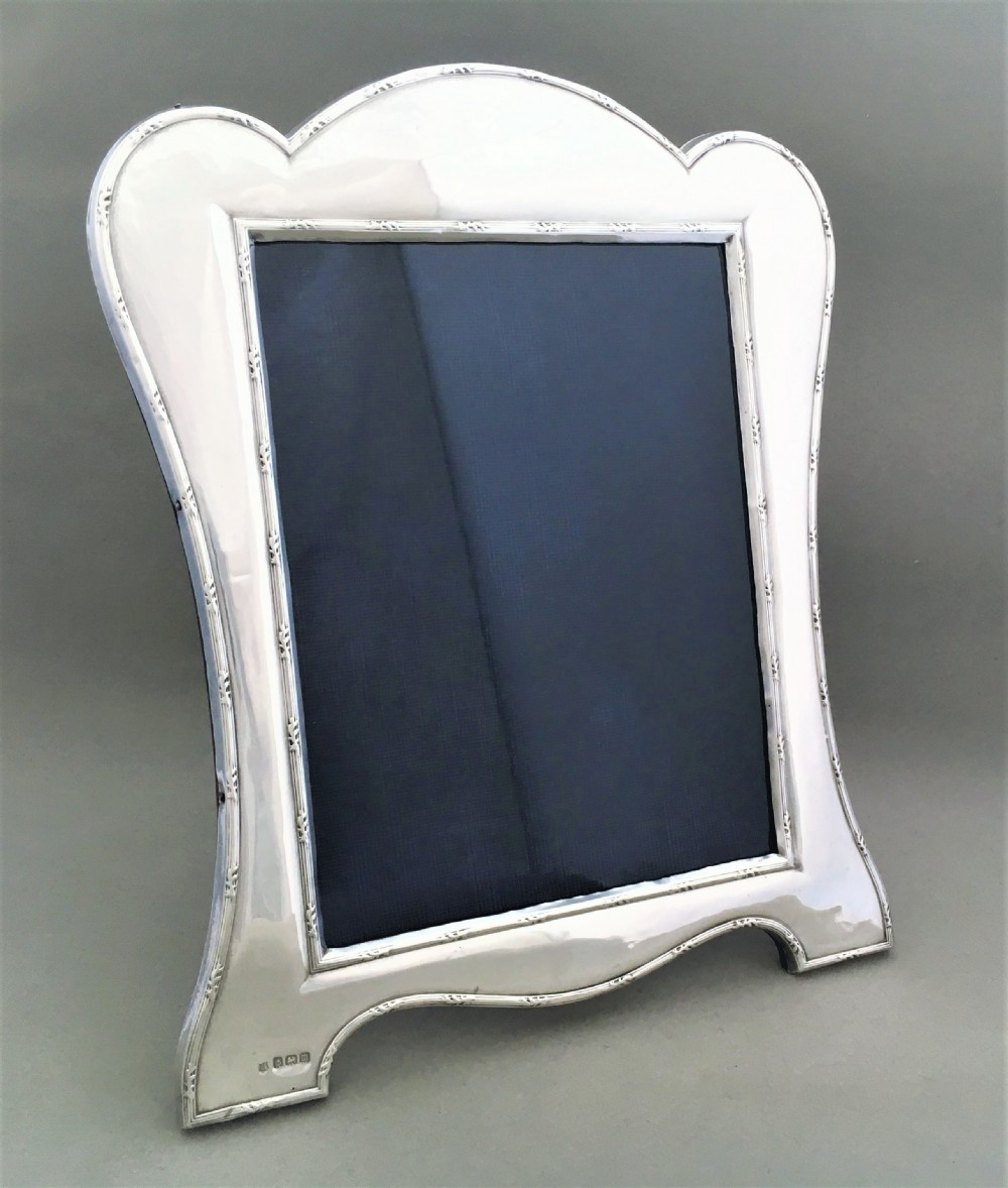 A decorative shaped silver photo frame