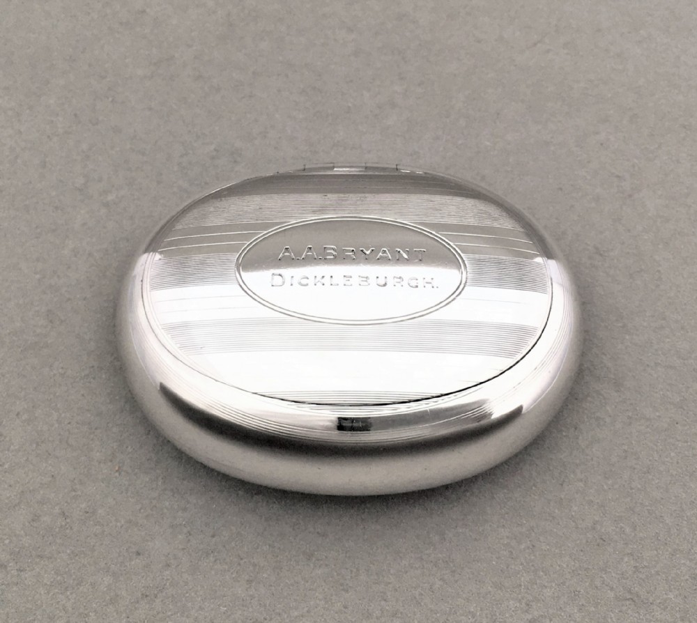 A charming Edwardian silver oval tobacco box