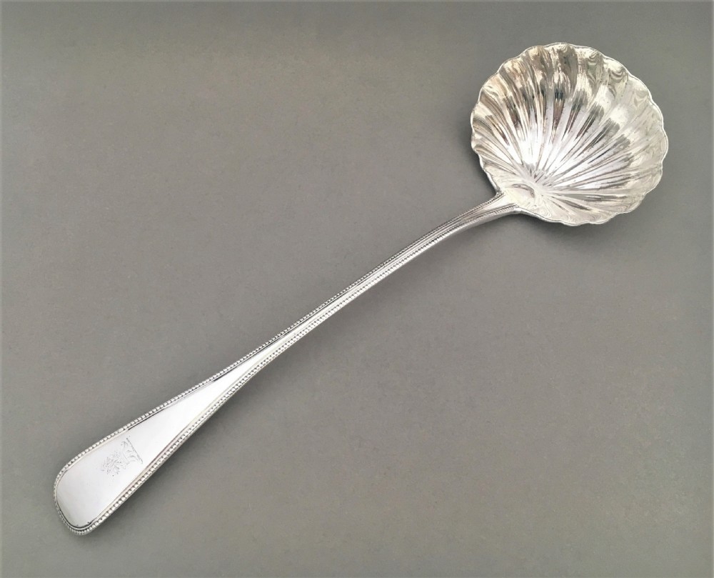 A superb George III silver shell bowl soup ladle