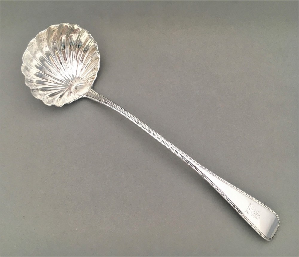A superb George III silver shell bowl soup ladle View II