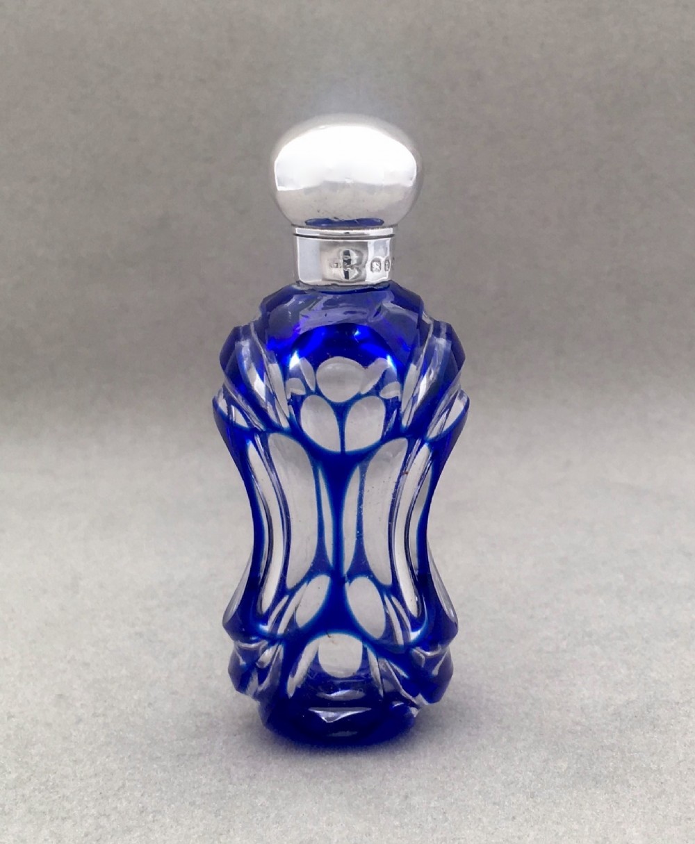 A Victorian silver mounted cut through scent bottle