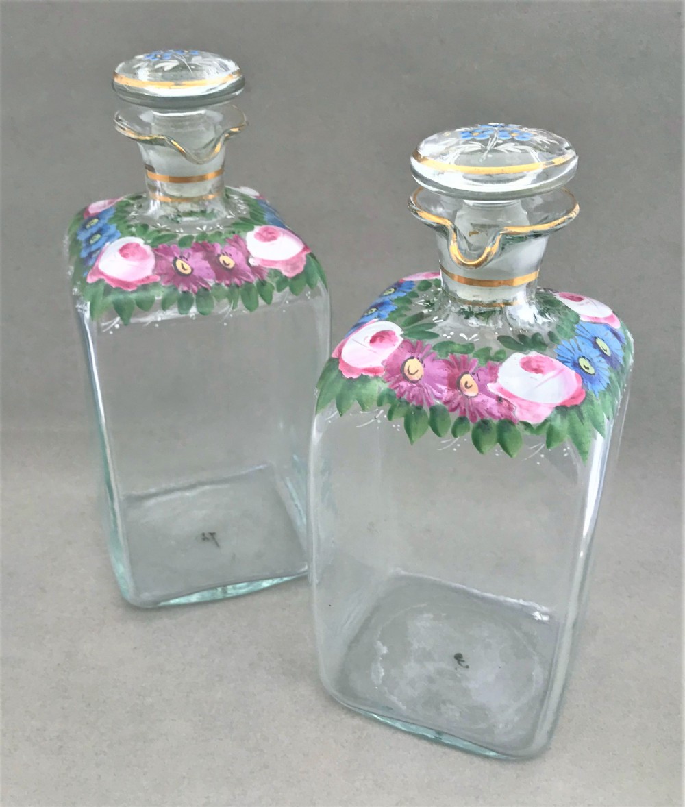 A gorgeous pair of spirit decanters with enamelled decoration