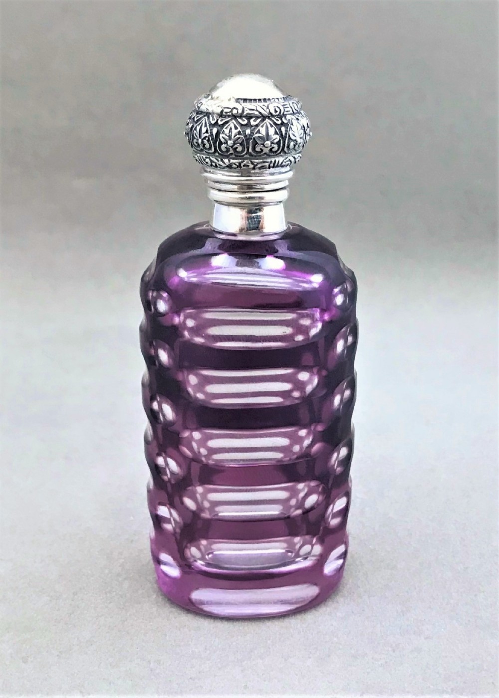 A gorgeous silver mounted cut through amethyst scent bottle