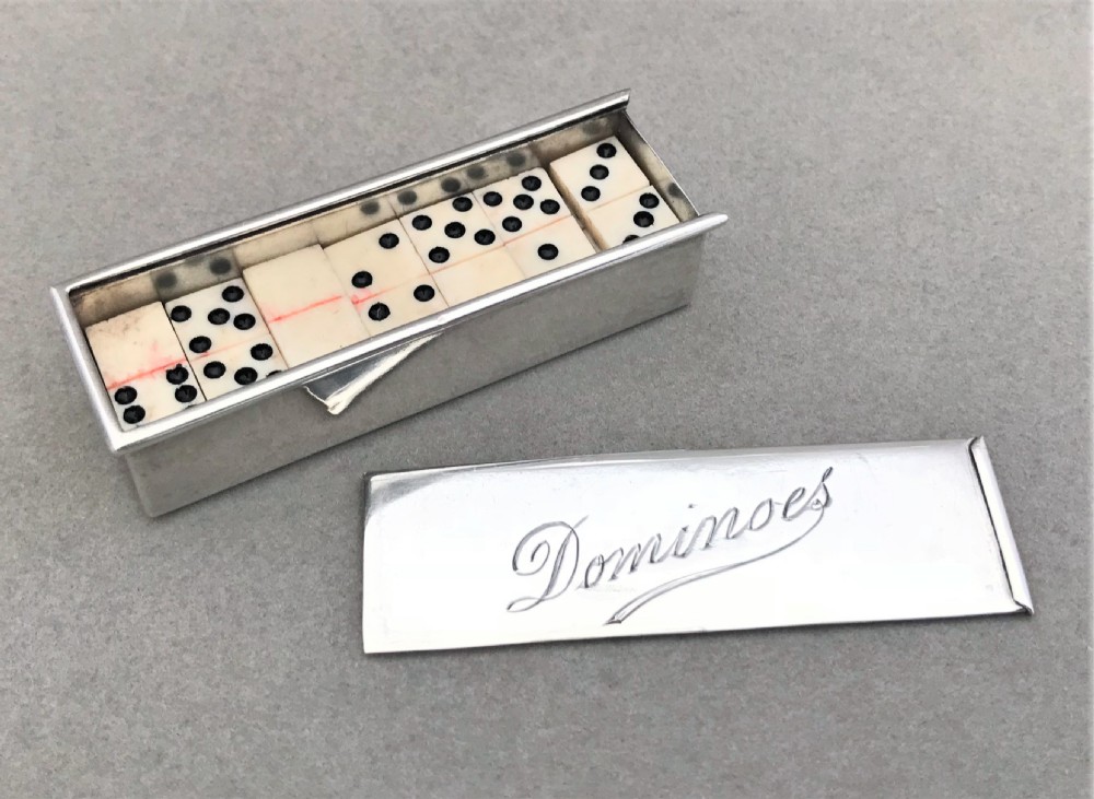 An extremely rare silver cased set of dominoes