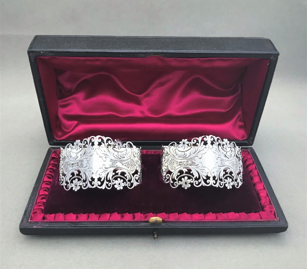 An exquisite boxed pair of silver napkin rings