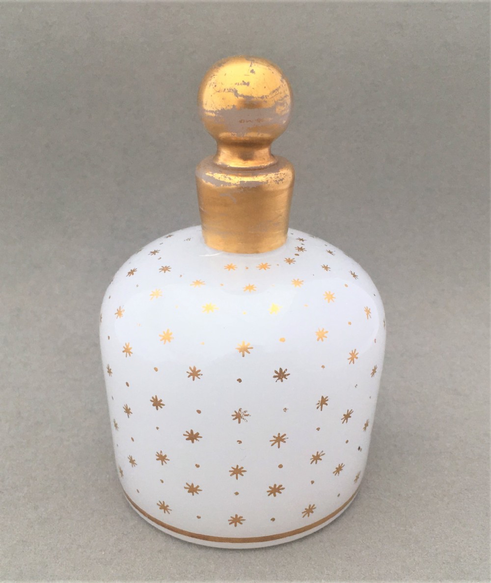 A fabulous star gilded opaline glass cologne bottle