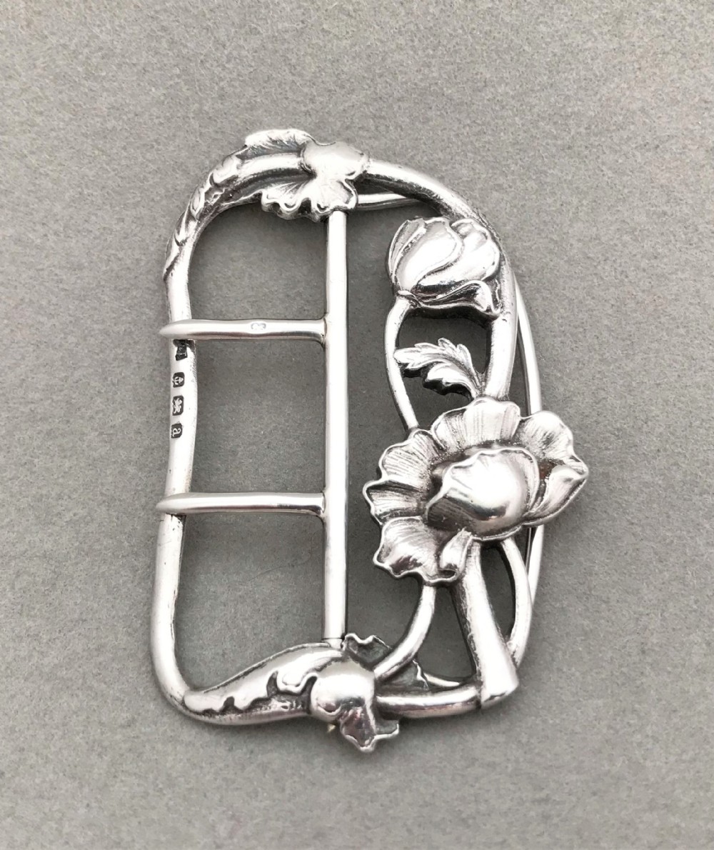 An exquisite cast silver belt buckle
