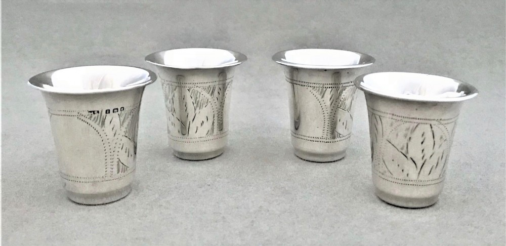 A rare set of four hallmarked silver shot or tot cups