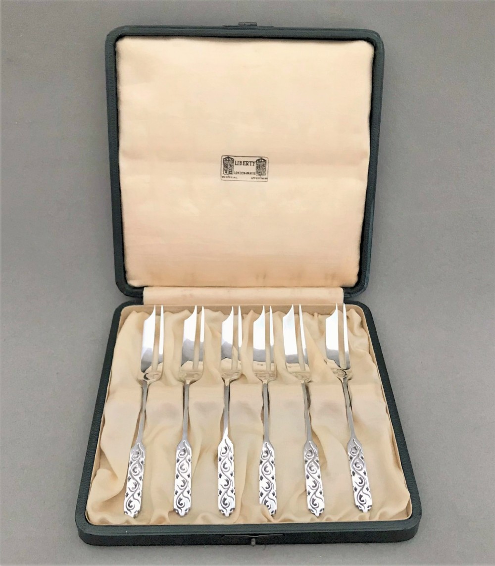 A cased set of Liberty & Co silver cake forks