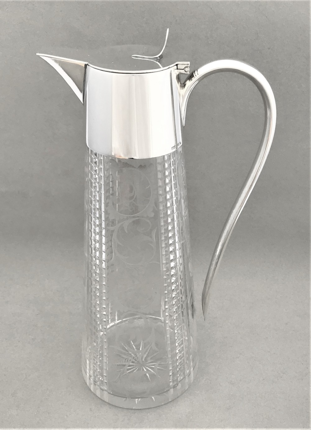A delightful silver plated claret jug