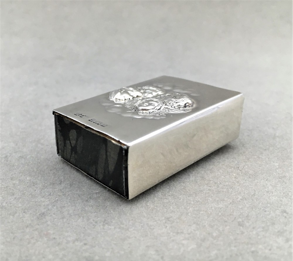 A silver Reynolds Angels embossed matchbox case View III