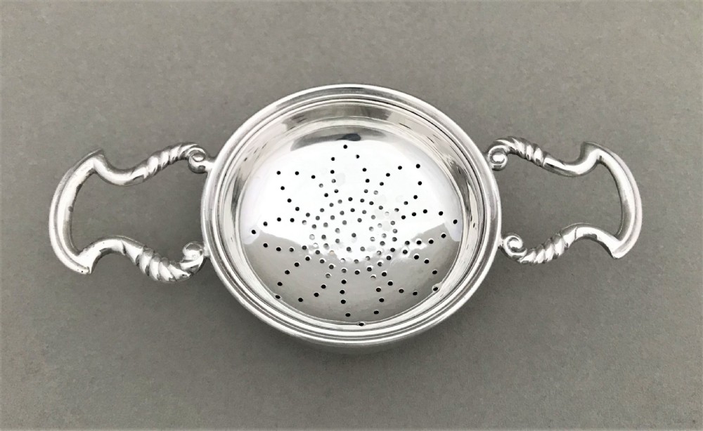 A charming silver tea strainer & drip cup View II