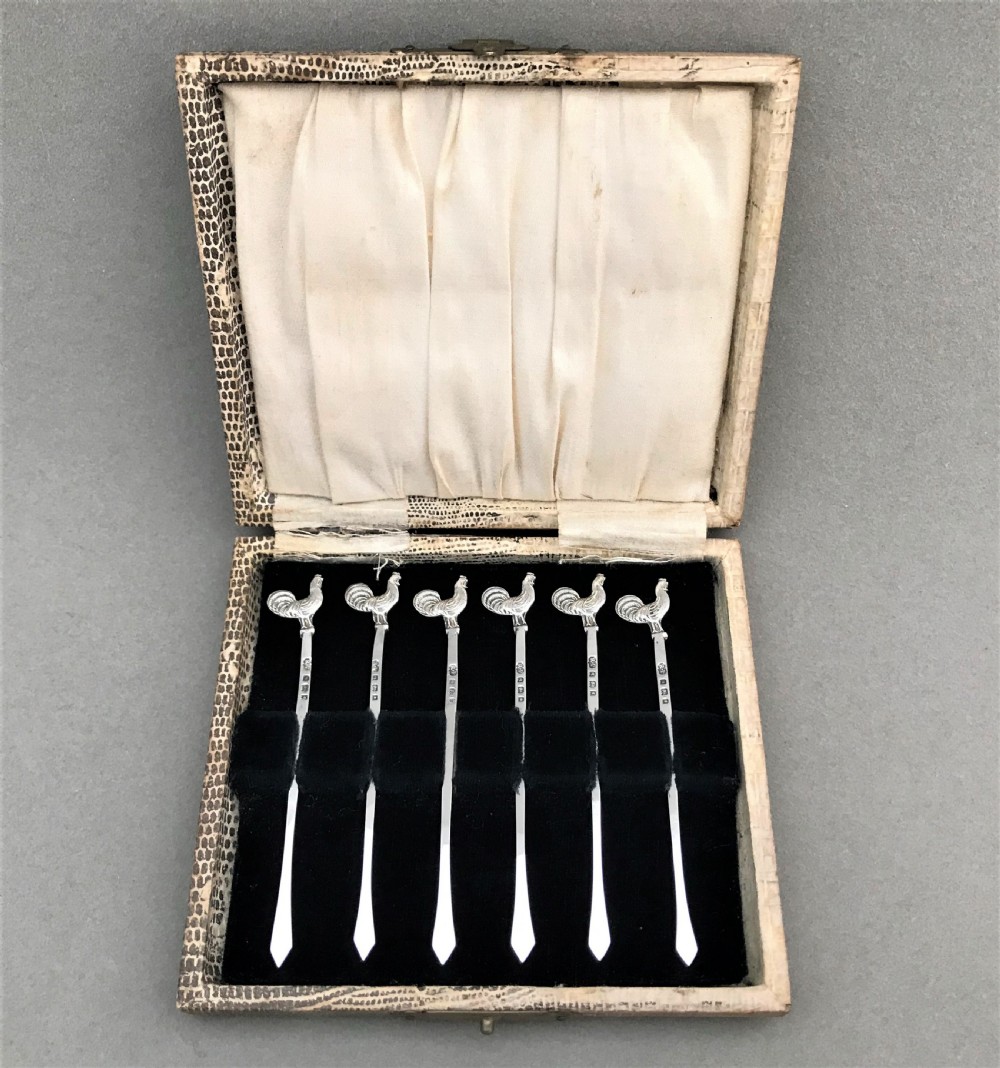 A hallmarked set of silver cockerel cocktail sticks