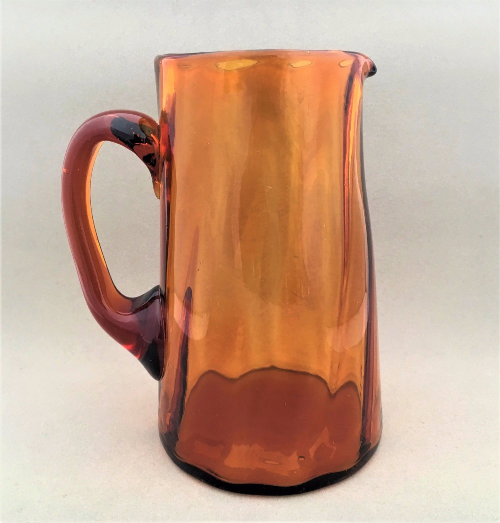 An unusual Victorian amber glass water jug
