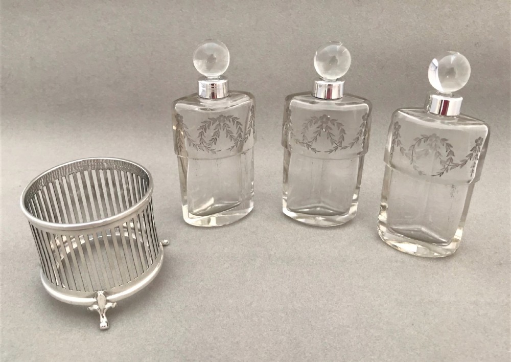 A gorgeous Edwardian silver mounted trio of scent bottles View V