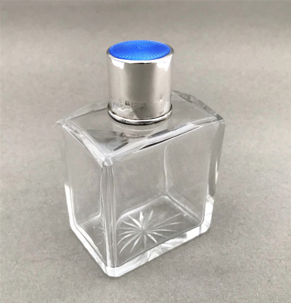 A silver & guilloche enamel mounted cologne bottle