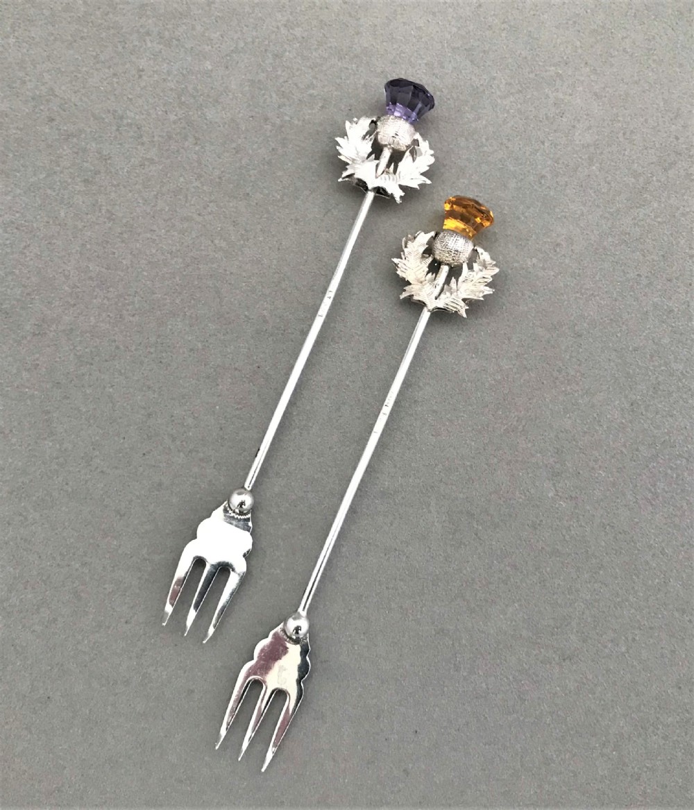 A charming pair of Chester silver 'thistle' pickle forks