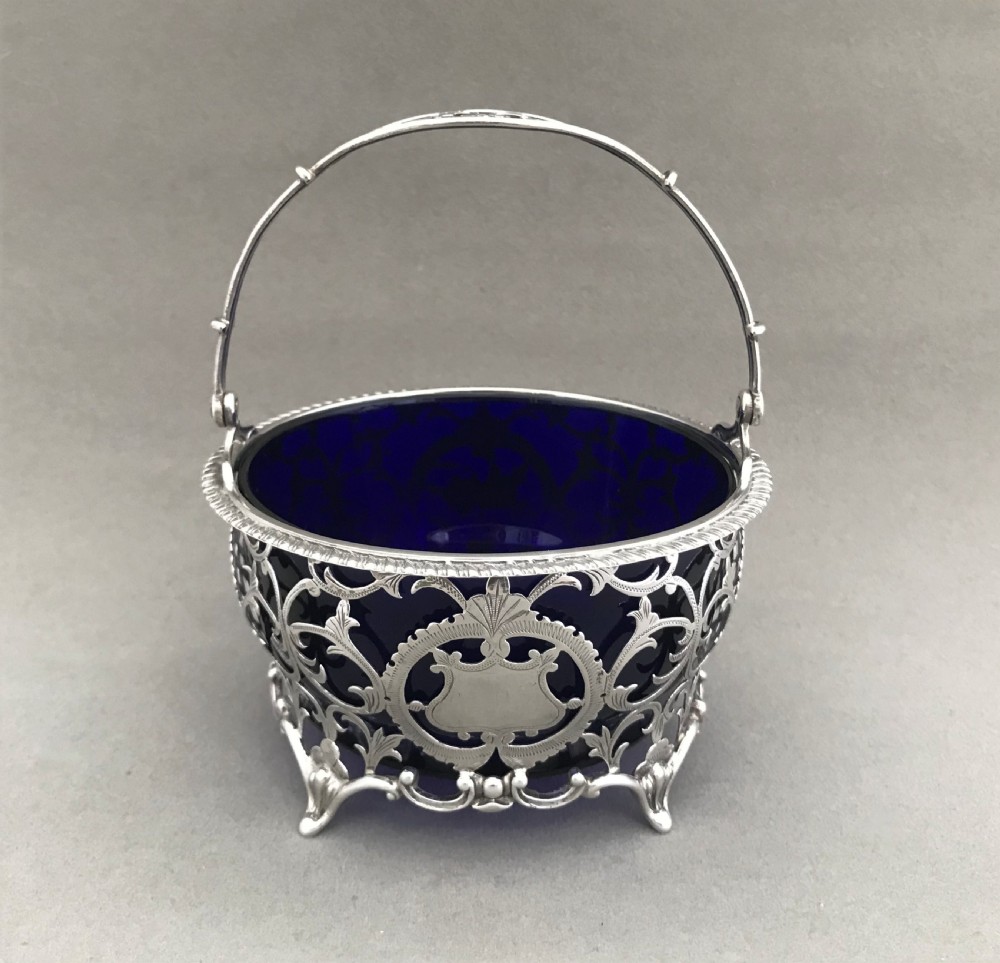 A superb pierced silver swing handled basket