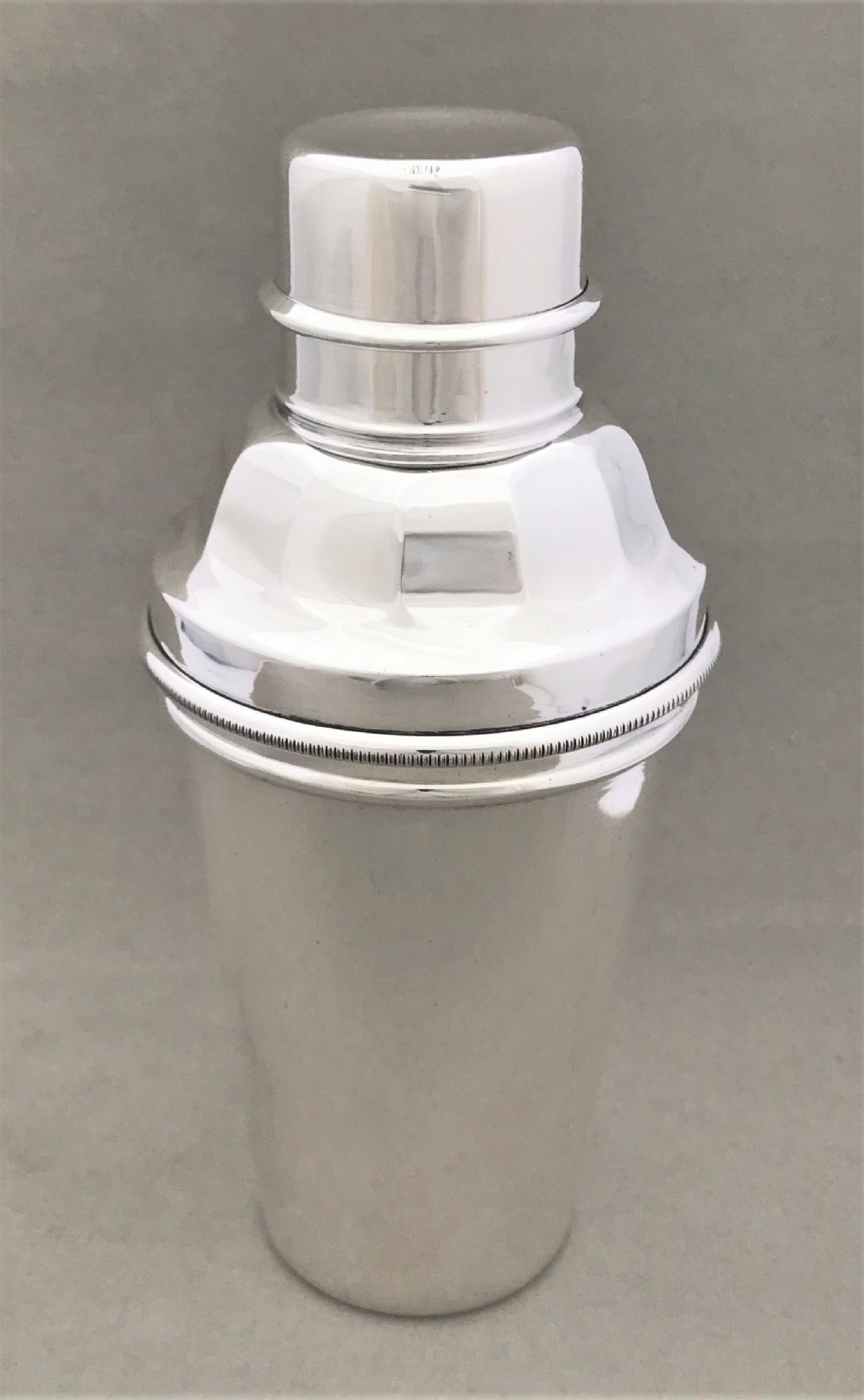 A rare silver plated cocktail shaker with lemon squeezer