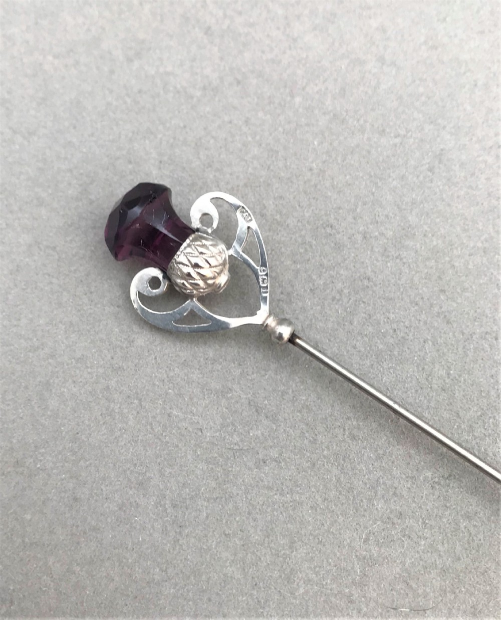 A gorgeous silver hatpin with thistle motif terminal