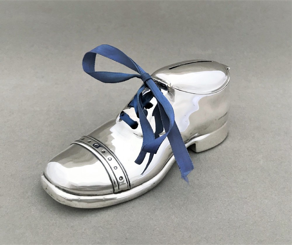 An extremely rare novelty silver 'shoe' money box