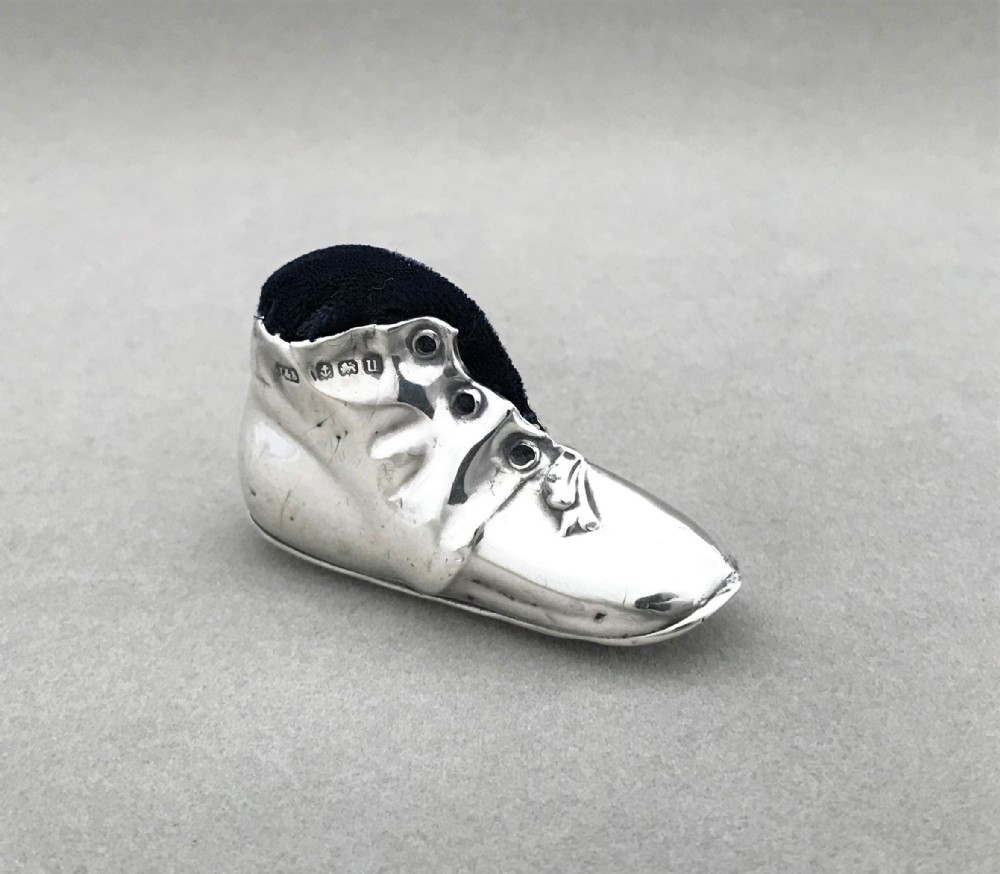 A delightful silver 'old boot' pin cushion